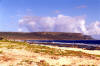 Tarague Beach, viewed from the eastern end with the northern most point - Ritidian Point, in the far distance. Tarague Beach area lies on the white sandy area near the next closest point. The sand is purest white. The reef is within walking distance but very treacherous and jagged with coral all along the beach and reef areas. The area between the two points is privately owned with similar beaches to Tarague.